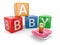 Baby from alphabetical blocks and dummy