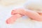 Baby Bare Feet From the Side on White Rug