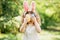 Baby with basket full of colorful eggs. Easter egg hunt.