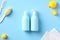 Baby bathing shampoo, body wash gel and accessories on blue background. Flat lay, top view. Daily baby care concept