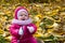 Baby in a beautiful autumn forest walks and enjoys a good Sunny weather.