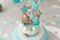 Baby birthday cake, gingerbread and bisquit decor. Tiffany color background.