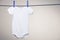 Baby bodysuit on clothesline