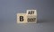 Baby boost symbol. Turned wooden cubes with words Boost and Baby. Beautiful grey background. Business and baby boost concept. Copy