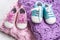 Baby booties pink and blue on a knitted bright microfiber rug. Ivf pregnancy concept.