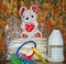 Baby bottle with fresh expresed milk, frozen breastmilk in storage bags and soft toy mouse