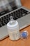 Baby bottle with milk and pacifier against laptop