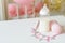 Baby bottles with breast milk with various festive paper decor. It`s a girl or baby birthday celebration concept.