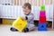 Baby boy age of 1 year plays nesting blocks