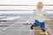 Baby boy in airport transit hall looking at airplane