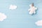 Baby boy background with white teddy bear toy on a clothesline and clouds