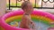 Baby-boy bathes in a pool