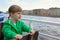 Baby boy on boat looking on water