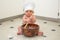 Baby Boy Chef with Blue Eyes Stirring in Bowl with Wooden Spoon