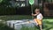 baby boy child walking playing with butterfly net on sandbox outdoors sunny day