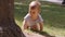 Baby boy crawling on the grass, outdoors on a windy day