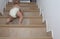 Baby boy crawling up the stairs