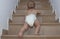 Baby boy crawling up the stairs