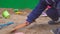 Baby boy digging in the sandbox. Smiles and touches the sand.