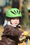 Baby boy in helmet learning to ride on bike