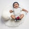 Baby boy infant fun photoshoot soccer football concept big smile having fun playing laughing laying on white furry round through s