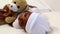 Baby boy lying in crib with teddy bear