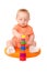 Baby boy in orange playing with toy tower