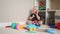 baby boy play in kindergarten. baby child play toys cubes and cars on the table in kindergarten. happy family preschool