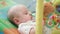 Baby boy playing with toy. Portrait of sweet kid playing with beanbag in bed