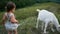 Baby boy plays with a goat