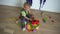 Baby boy plays play assembly constructor parts on wooden floor. Gimbal motion