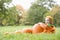 Baby boy in pumpkin costume with pumpkins