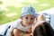 Baby boy resting above motherâ€™s shoulder and looks out with focused blue eyes curious expression