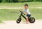 Baby boy riding with balance bicycle