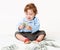 Baby boy sitting on floor with money banknotes