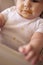 Baby boy sitting in high chair stained and messy after meal