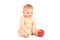 Baby boy sitting and looking at an apple