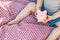 Baby Boy Sitting on Picnic Blanket Playing With Piggy Bank