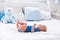 Baby boy in white sunny bedroom