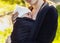 Baby on the breast of the mother. Newborn woven wrap babywearing