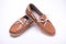 Baby brown loafers on white background