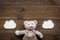 Baby care. Newborn baby concept. Baby sleep concept. Teddy bear toy near clouds on dark wooden background top view copy