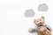 Baby care. Newborn baby concept. Baby sleep concept. Teddy bear toy near clouds on white background top view copy space