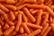 Baby carrots texture background, top view