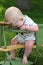 Baby chewing on beads on antique stroller outdoors