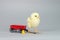 Baby Chick with Little Red Wagon Small Toy Duck Gray Background