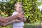 Baby chicken in hands of adult with child touching its feathers.