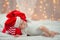 Baby in a Christmas hat with Santa Claus red bag