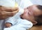 Baby with cleft lip, milk and mom feeding from bottle for nutrition, health and wellness. Formula, newborn and hand of
