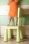 Baby climbing on chair. Kids safety conception.